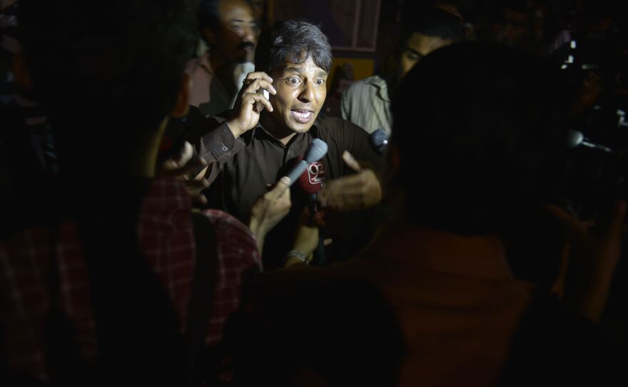 An eyewitness talks with media representatives after the explosion at the park, where families were gathered to enjoy springtime weather.