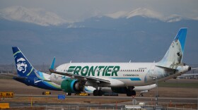 A Frontier Airlines jetliner waits for clearance to take off as high winds strafe Denver International Airport Thursday, March 12, 2026, in Denver.