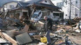 Callum Macrae stands amid destruction and debris in Ofunato, Japan.  