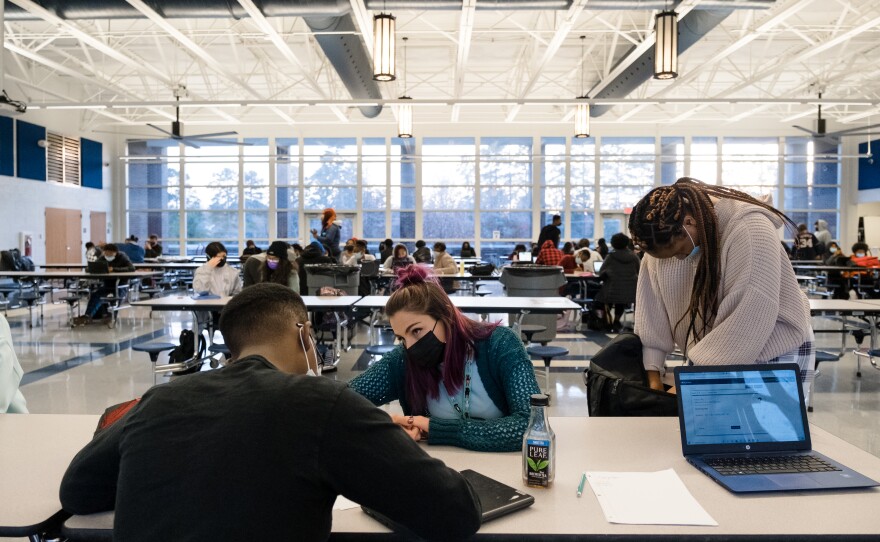 Sierra Hannipole helps Dreshon Robinson with biology during the learning hub. The hub is open to all students Monday through Thursday after school. Students can get help with schoolwork or see a counselor. There's also free food.