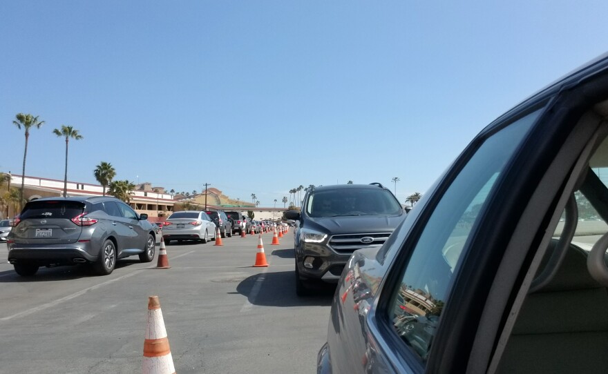 A line of patients in cars waiting to get a COVID-19 vaccine at the Del Mar Vaccination Super Station. March 8, 2021.