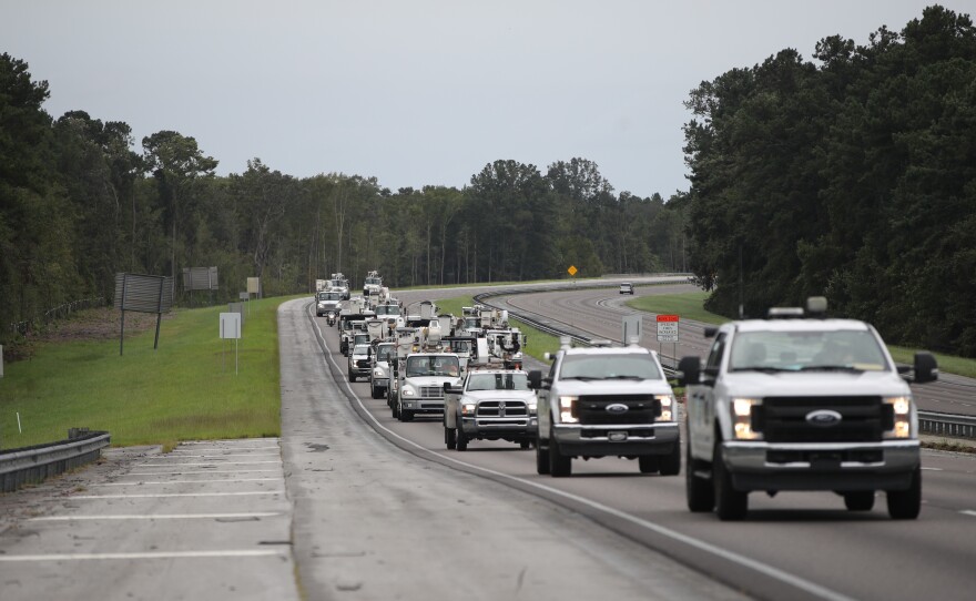 Utility trucks move in Monday as the outer bands of Hurricane Dorian approach in Charleston, S.C. Residents in Charleston and many other coastal areas are under an evacuation order.
