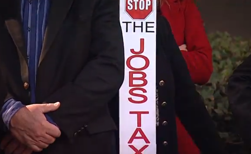 Members of the Jobs Coalition raised signs in protest downtown Dec. 11, 2013 in opposition to the San Diego City Council’s vote to increase the linkage fee, or "jobs tax."