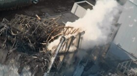 In this photo taken Wednesday and released Friday by Tokyo Electric Power Co. via Kyodo News, smoke billows from Unit 3 at the Fukushima Dai-ichi nuclear power plant. Emergency crews worked to reconnect electricity to cooling systems and spray more water on overheating nuclear fuel Friday.