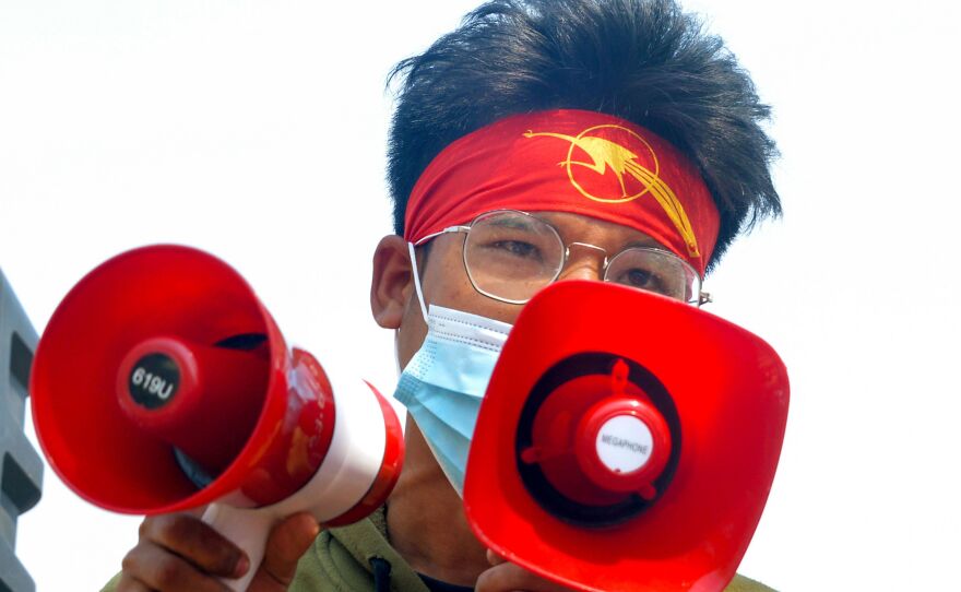 A protester wearing a headband featuring a students' union logo addresses a crowd during a demonstration against the military coup in Naypyidaw, Myanmar, on Feb. 28.