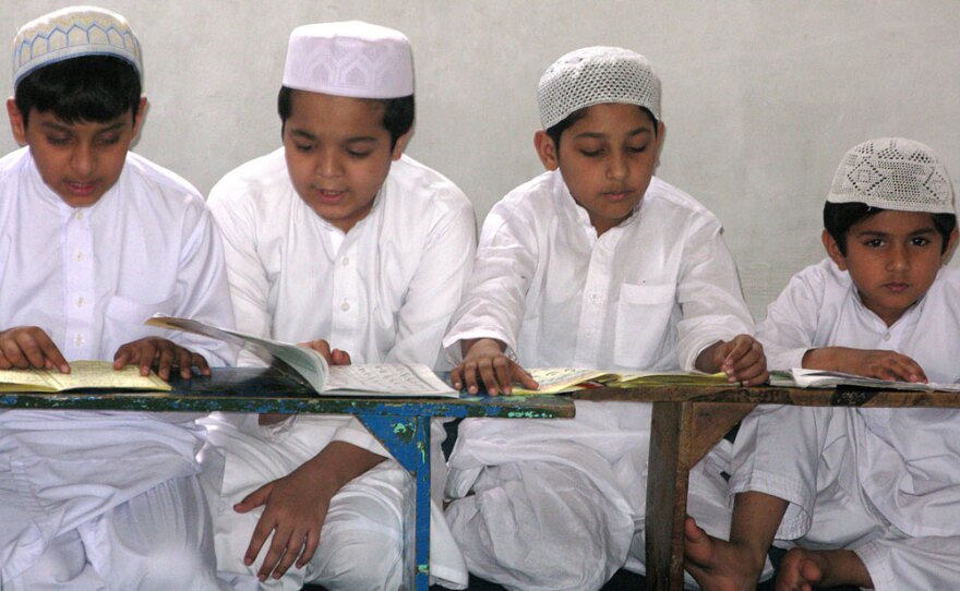 Boys study the Quran at the Jamia Ashrafia madrassa in Lahore. Tuition is free, a major draw for many of the city's poor.