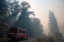 A fire truck drives into the smoke of the Caldor Fire