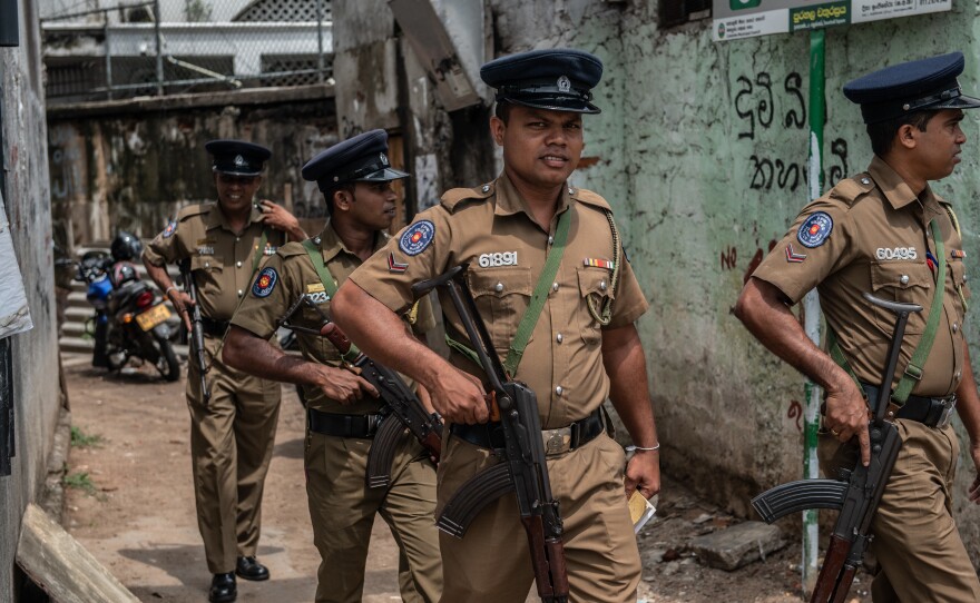 Police officers patrol the area around Dawatagaha mosque ahead of prayers on Friday in Colombo, Sri Lanka.