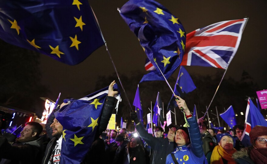 Anti-Brexit demonstrators react after the results of the vote on British Prime Minister Theresa May's Brexit deal were announced in Parliament square in London on Tuesday. British lawmakers have rejected Prime Minister Theresa May's Brexit deal by a huge margin, plunging U.K. politics into crisis 10 weeks before the country is due to leave the European Union.
