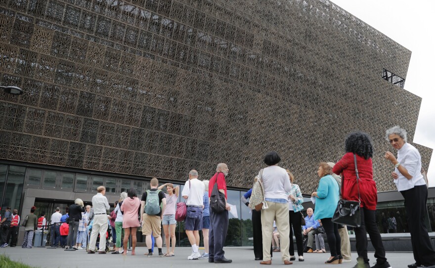 Lucille Simpson, far right, and her daughter Gwendolyn Norman, both from Detroit, Mich., wait in line to enter the Smithsonian National Museum of African American History and Cultural on the National Mall in Washington, D.C., on May 1.