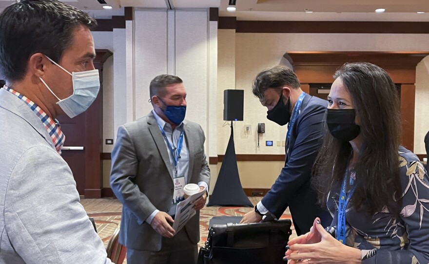 Jen Easterly, director of the Department of Homeland Security's Cybersecurity and Infrastructure Security Agency, speaks with Ohio Secretary of State Frank LaRose, left, during the summer meeting of the National Association of Secretaries of State.