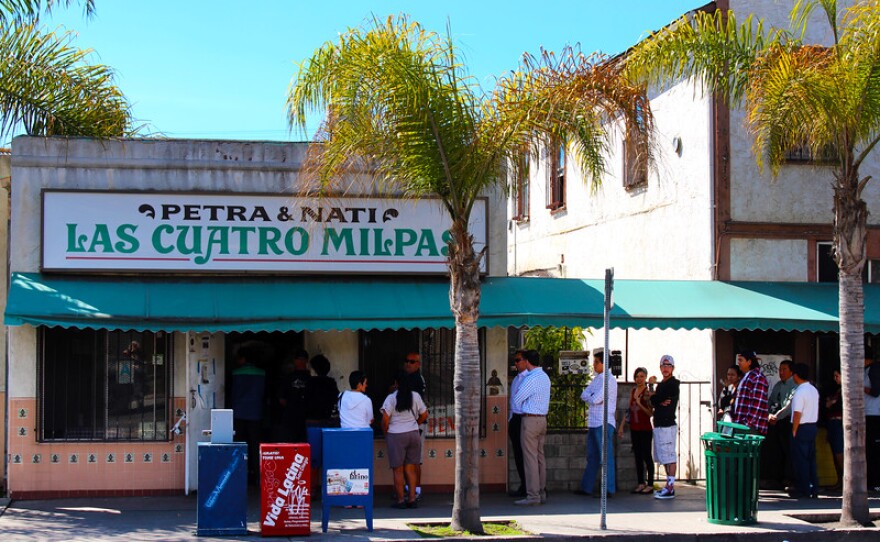 A line of people wait to order at the former location of Las Cuatro Milpas in this undated image.