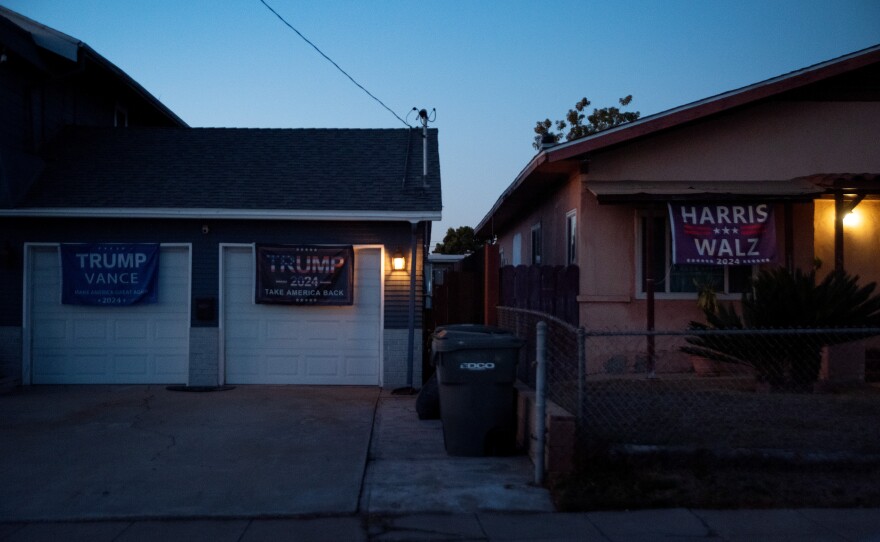 Dueling Trump-Vance and Harris-Walz flags hang outside two National City homes on Jan. 9, 2025.
