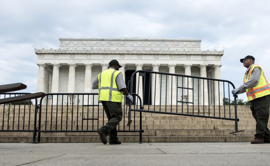 Members of the U.S. Park Service place barricades around the Lincoln Memorial on Tuesday in Washington, D.C. A partial shutdown of the federal government has led to the closing of national parks.