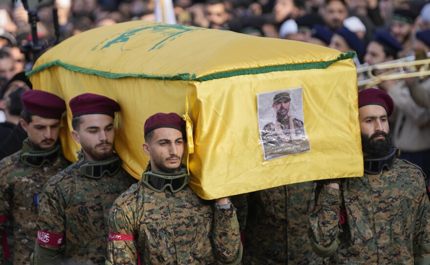 Hezbollah fighters carry the coffin of senior Hezbollah commander Wissam Tawil, during his funeral procession in the village of Khirbet Selm, south Lebanon, on Tuesday. The elite Hezbollah commander was killed in an Israeli airstrike on Monday in southern Lebanon.