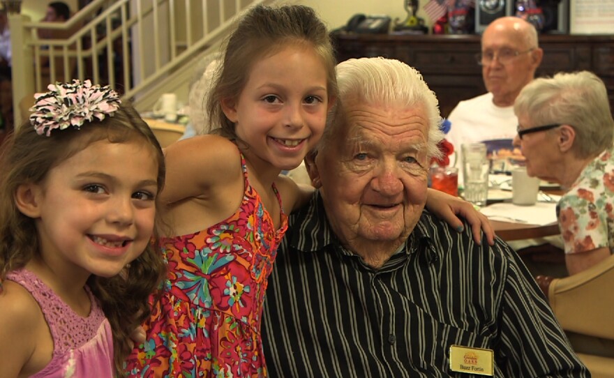 USS Indianapolis survivor Verlin "Buzz" Fortin poses with his great-granddaughters at the Golden Oaks Senior Living Community in Yucaipa, California, on July 30, 2014.