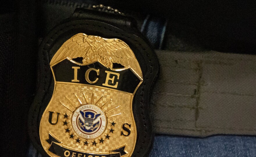 FILE - A federal agent wears an Immigration and Customs Enforcement badge in New York, June 10, 2025.