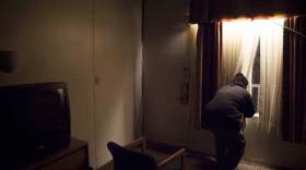 Saeed Shariff Torres visits a motel, after completing his role in the FBI counterterrorism investigation of Khalifah Al-Akili. He often feels unsafe, in part due to his 23 years working for the Bureau providing intelligence.