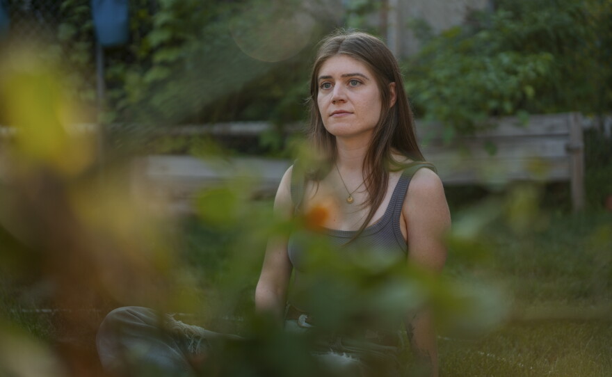 Joselyn Walsh, a musician, sits for a portrait at her home on July 30, 2026, in Chicago, Ill. Walsh was charged with federal conspiracy offenses following a 2025 protest, but the charges were later dismissed after alleged prosecutorial misconduct.