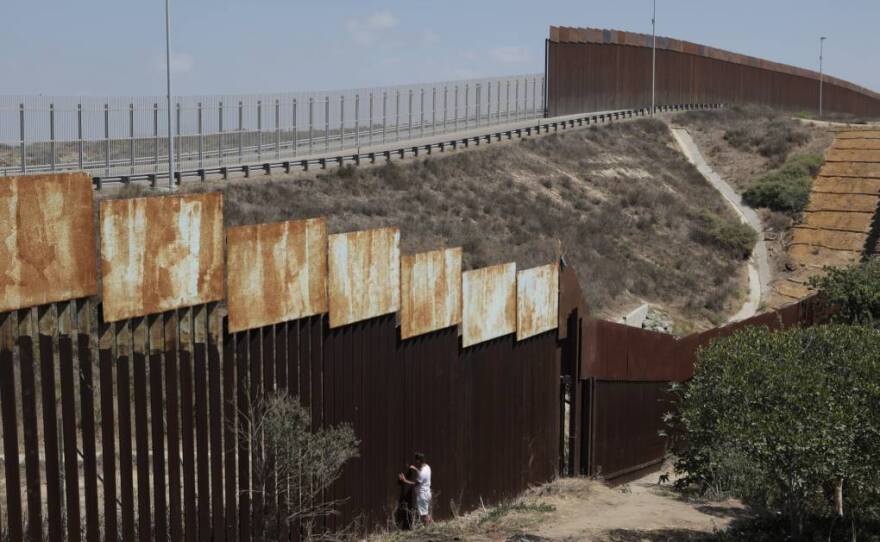 Luna Guzmán stands at the border fence in Tijuana, at the section she had climbed across in January 2019 during her second attempt to immigrate to California. She had been deported the year before after giving up her asylum claim, unable to withstand long months of detention and sexual harassment at the detention center.