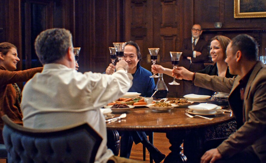 Scott Yoo and others gathered at the table raising a glass