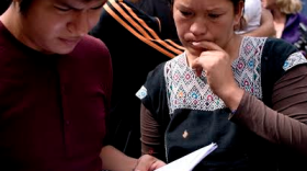 Elvira Arellano looks over her parole papers with a fellow activist in San Diego, March 20, 2014.