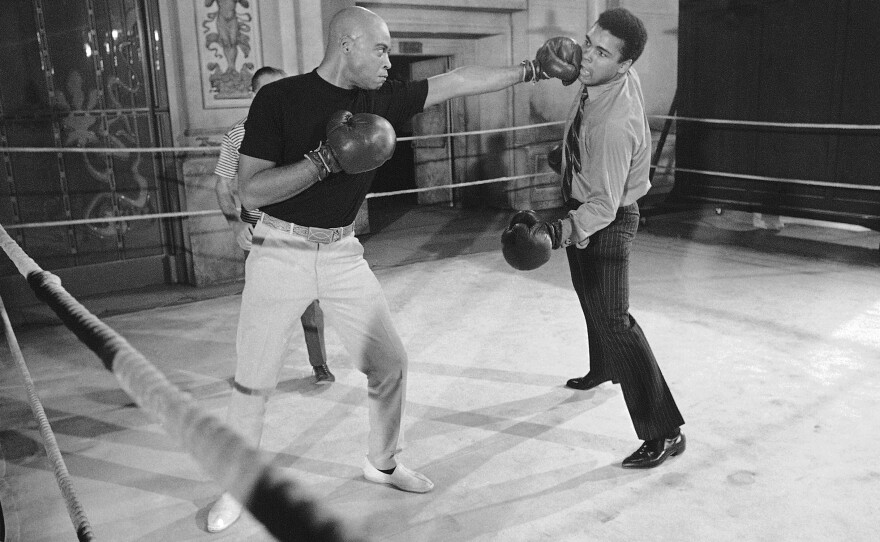 Muhammad Ali (right) takes on James Earl Jones in the ring. When this photo was captured in 1969, Jones was making the film <em>The Great White Hope</em> and Ali dropped by to help drum up publicity.