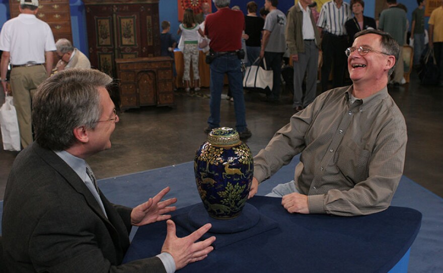 Stuart Whitehurst (left) appraises a Pilkington Royal Lancastrian urn, ca. 1905 in Providence, R.I.