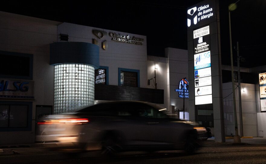 A car drives past Dr. Valente Mérida's asthma clinic at night in Mexicali on Aug. 8, 2024.