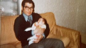 Constantine Tsioulcas, holding his daughter Anastasia as a baby.