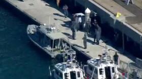 Law enforcement surrounds Navy boat where shooting took place.