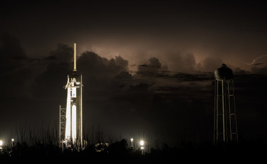The Dragon crew capsule sits atop a Falcon 9 rocket on Friday, May 29, 2020 as distant storms roll by. NASA and SpaceX cannot launch unless the weather is perfect.