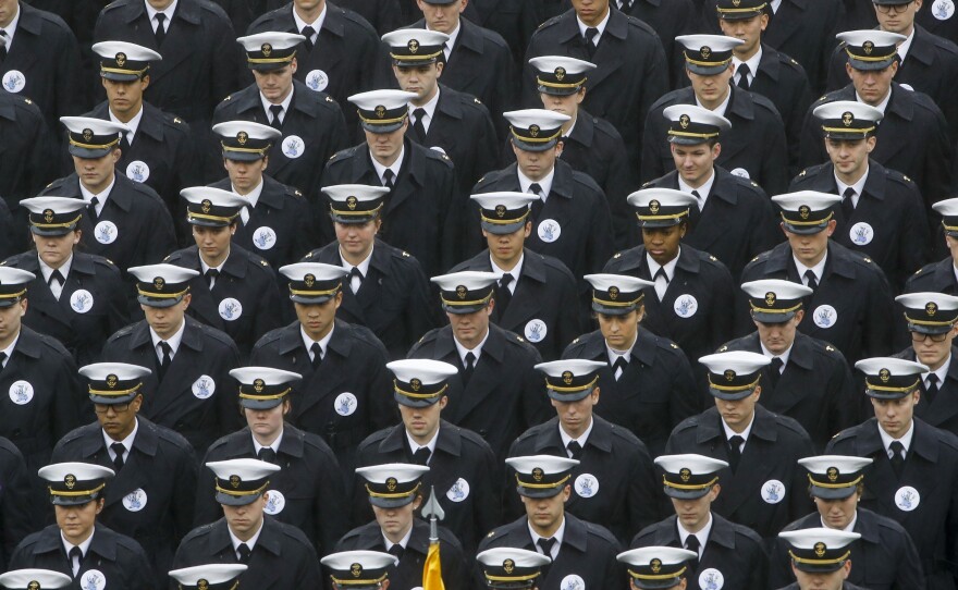Navy midshipmen march onto the field ahead of the annual NCAA college football game between the Army and the Navy in Philadelphia on Dec. 14.