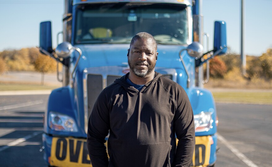 Heavy haul trucker Eric Jammer stands in front of his truck.
