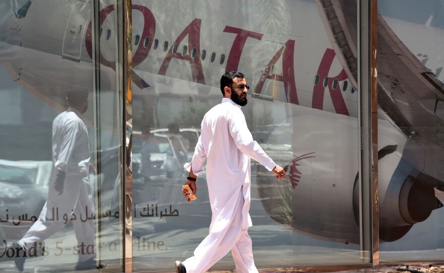 A man walks past the Qatar Airways branch in the Saudi capital, Riyadh, on Monday. Saudi Arabia and other Gulf states severed relations with Qatar and restricted Qatari planes' use of their airspace.
