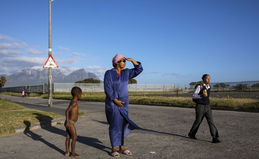 Debbie watching Zobi enter the school gates. In August 2013, all schools in Manenberg were once again temporarily closed after a spike in gang violence killed or wounded at least 50 people. 2014.
