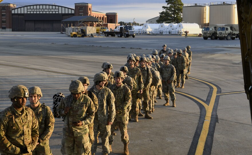 Soldiers from the 541st Sapper Company headed to the southern U.S. border prepare to board an air transport plane on Tuesday in Ft. Knox, Ky.