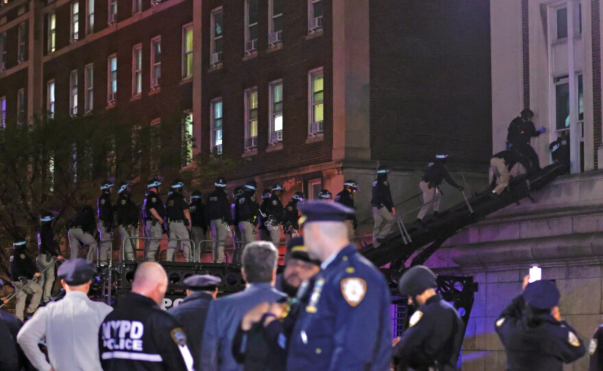 NYPD officers in riot gear break into a building at Columbia University, where pro-Palestinian students are barricaded inside a building and have set up an encampment, in New York City on April 30, 2024.