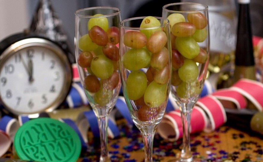 Champagne flutes filled with grapes.