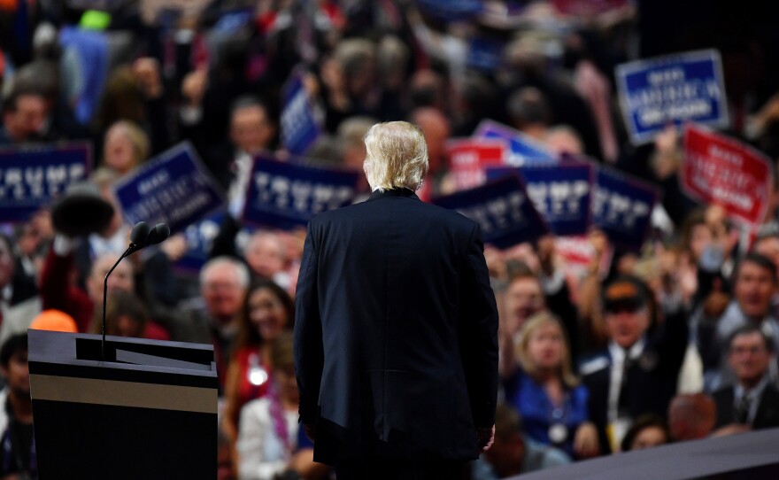 Trump pauses and turns to the crowd during his acceptance speech.