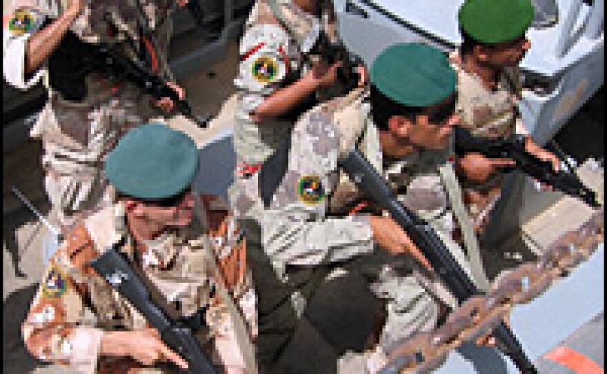 Iraqi marines prepare to board an improvised ship during a training exercise.