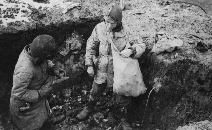 Two boys fill a sack with potatoes that had been hidden during Ukraine's devastating famine in the 1930s.