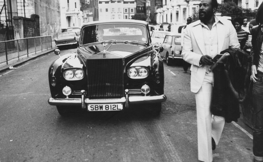 Marvin Gaye walks ahead of his Rolls Royce in Notting Hill, London in 1976.