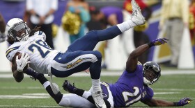 San Diego Chargers running back Melvin Gordon (28) is upended by Baltimore Ravens cornerback Lardarius Webb (21) during the second half of an NFL football game in Baltimore, Nov. 1, 2015. 