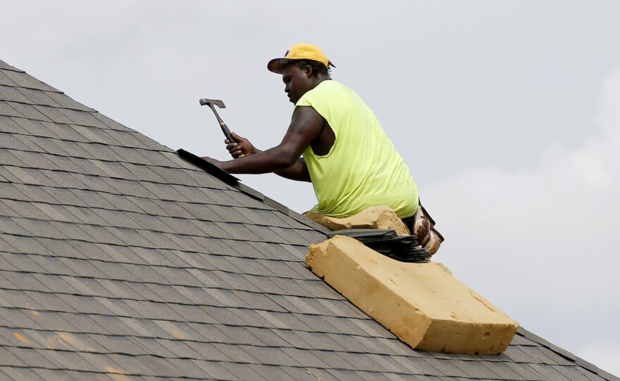 A construction worker lays down shingles on the roof of a new house in Brandon, Miss., on June 19. Construction jobs rose 4,000 in July — below the 18,000 added in June and the 19,000 added in July 2018.