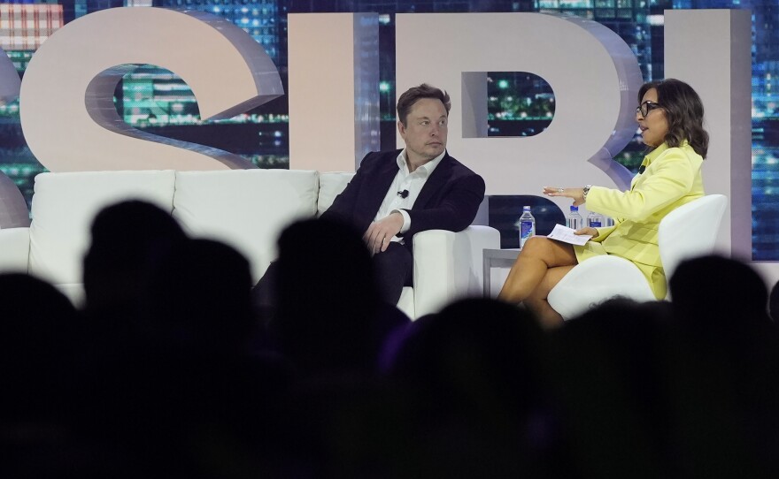 Elon Musk speaks with Linda Yaccarino, then-chairman of global advertising and partnerships for NBC, at the POSSIBLE marketing conference on April 18 in Miami Beach, Fla.