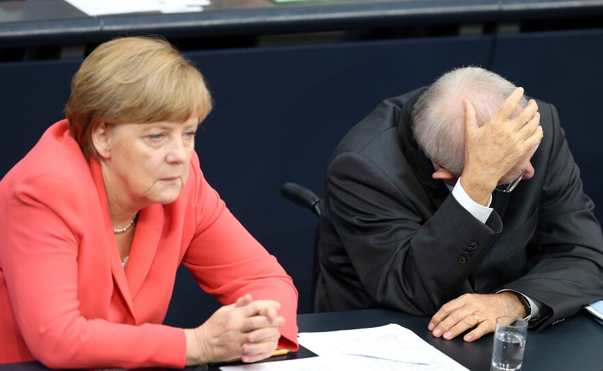 German Chancellor Angela Merkel and German Finance Minister Wolfgang Schaeuble talking during a special meeting of the German parliament over the proposed bailout package for Greece.