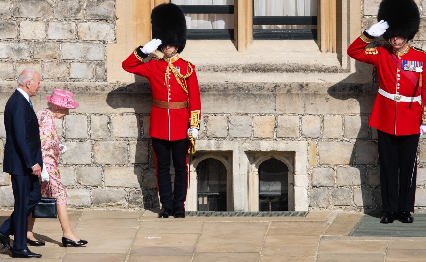 Queen Elizabeth II and President Biden walk at Windsor Castle on Sunday in Windsor, England. This is Biden's first private meeting with Queen Elizabeth II since becoming president.