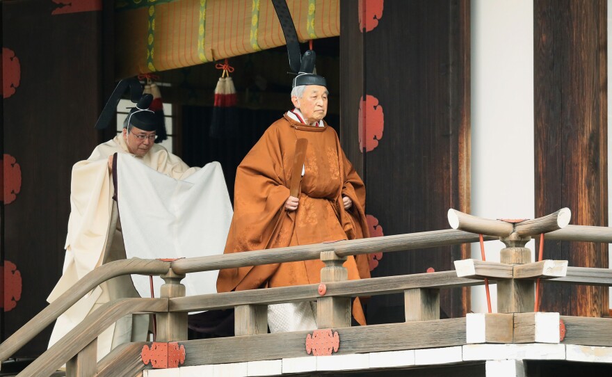 Japan's Emperor Akihito (right) leaves after a ritual to report his abdication to the throne at the Imperial Palace in Tokyo on Tuesday.