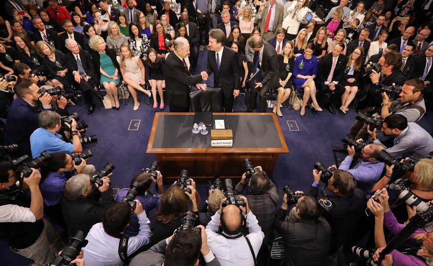 Supreme Court nominee Judge Brett Kavanaugh, right, is greeted by committee chairman Sen. Chuck Grassley , R-Iowa, as Kavanaugh arrives for testimony before the Senate Judiciary Committee during his Supreme Court confirmation hearing Monday in Washington, D.C.